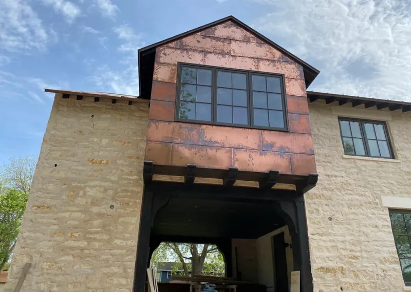 Copper metal panel facade on a stone building for Skylight Installation in El Monte