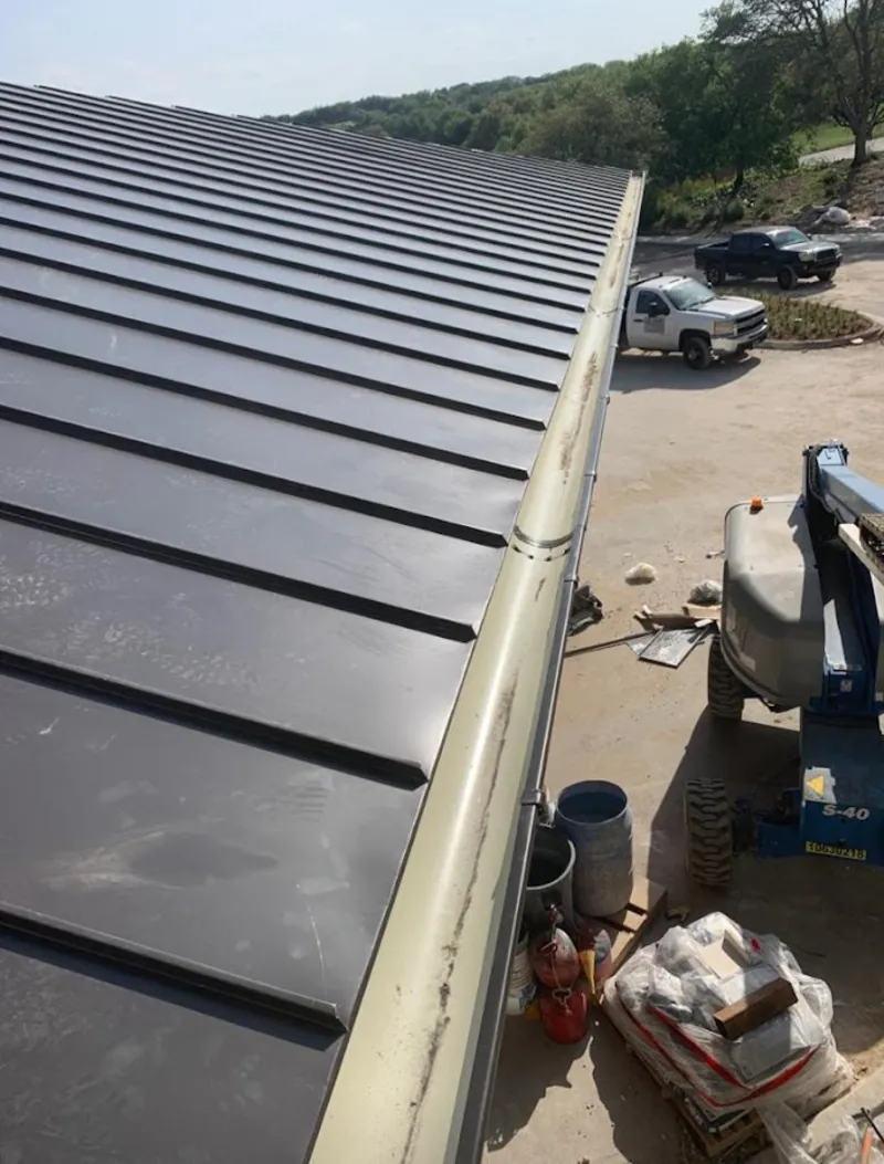 Standing seam panel and gutter detail on a metal roofing jobsite in El Monte